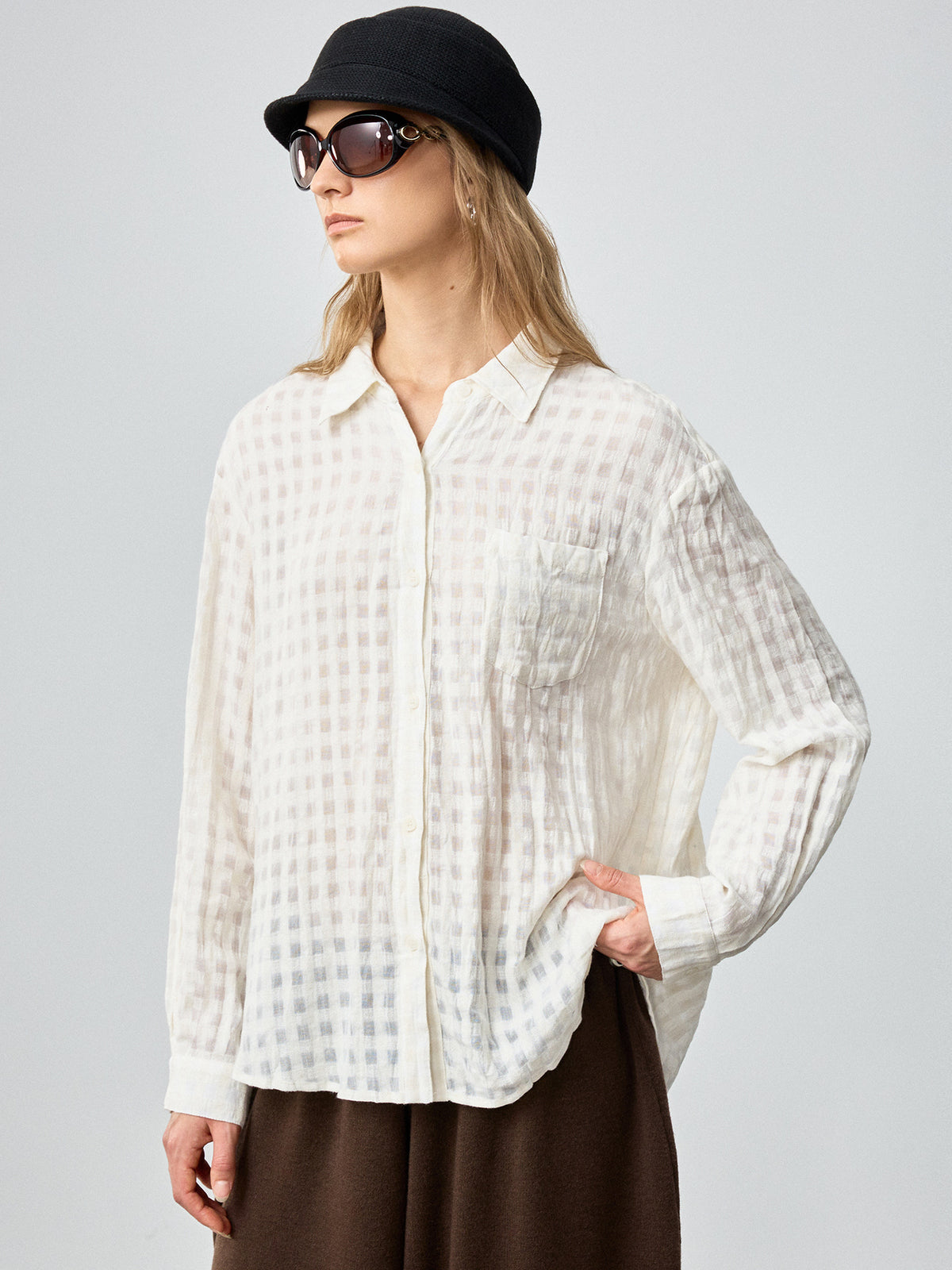 Off-white plaid button-front shirt with long sleeves, collar, and relaxed fit