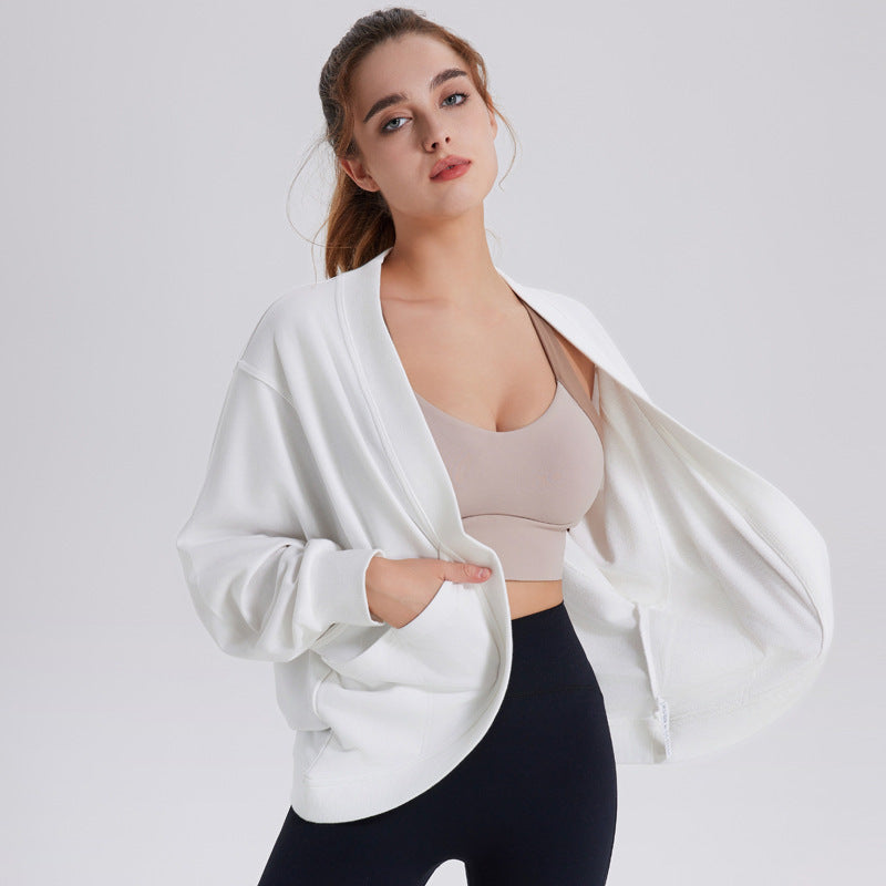 Women’s white long-sleeve athletic cardigan top, open front, relaxed drape