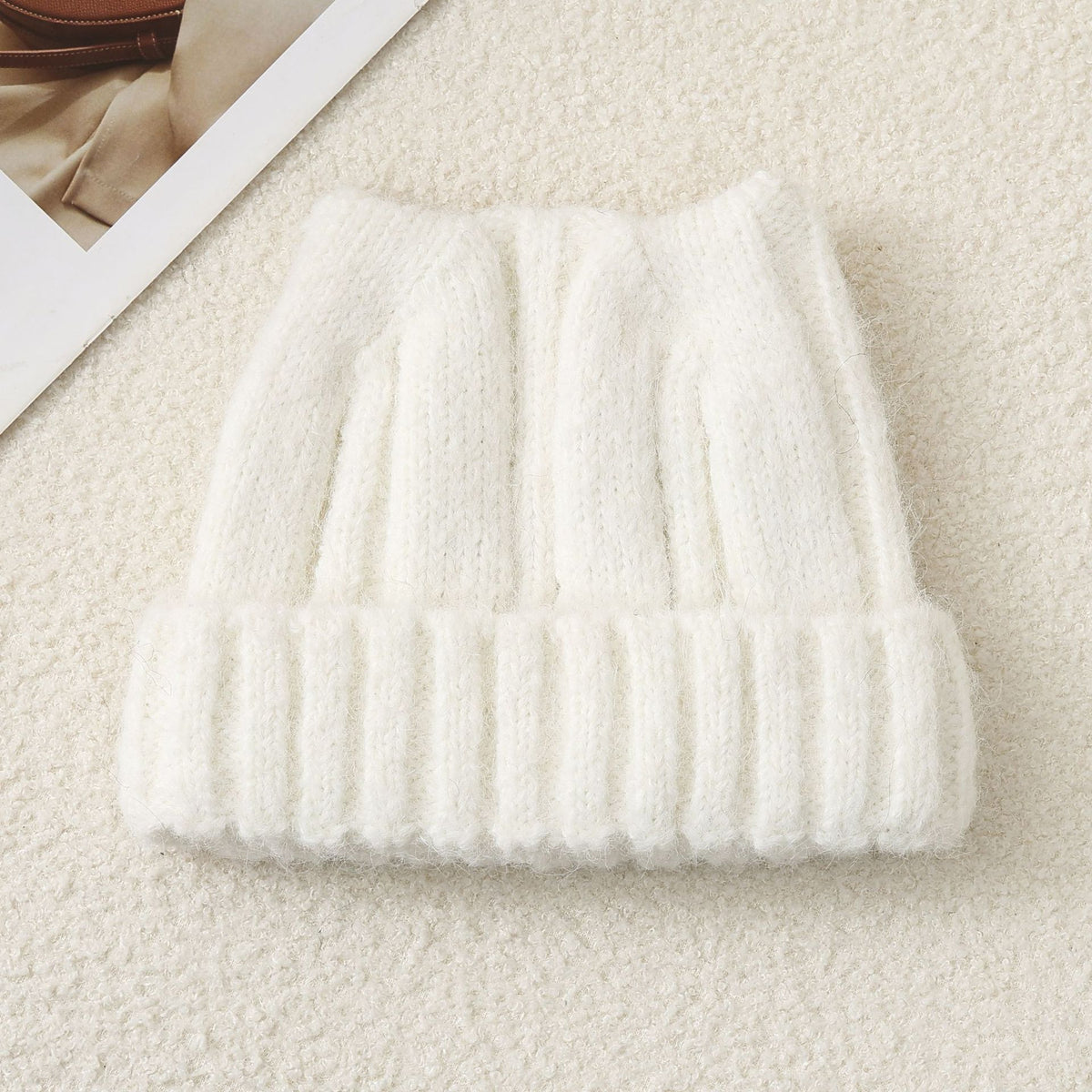 Cream knitted beanie hat with ribbed brim and textured knit crown