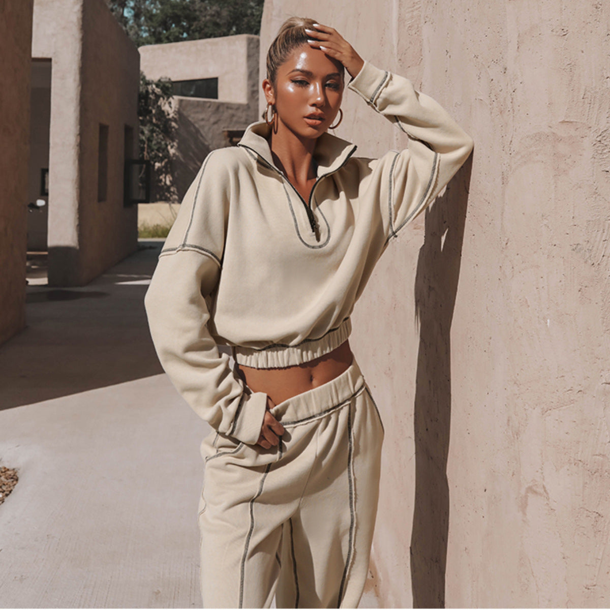 Women's light beige quarter-zip sweatshirt and matching jogger set with elastic waist