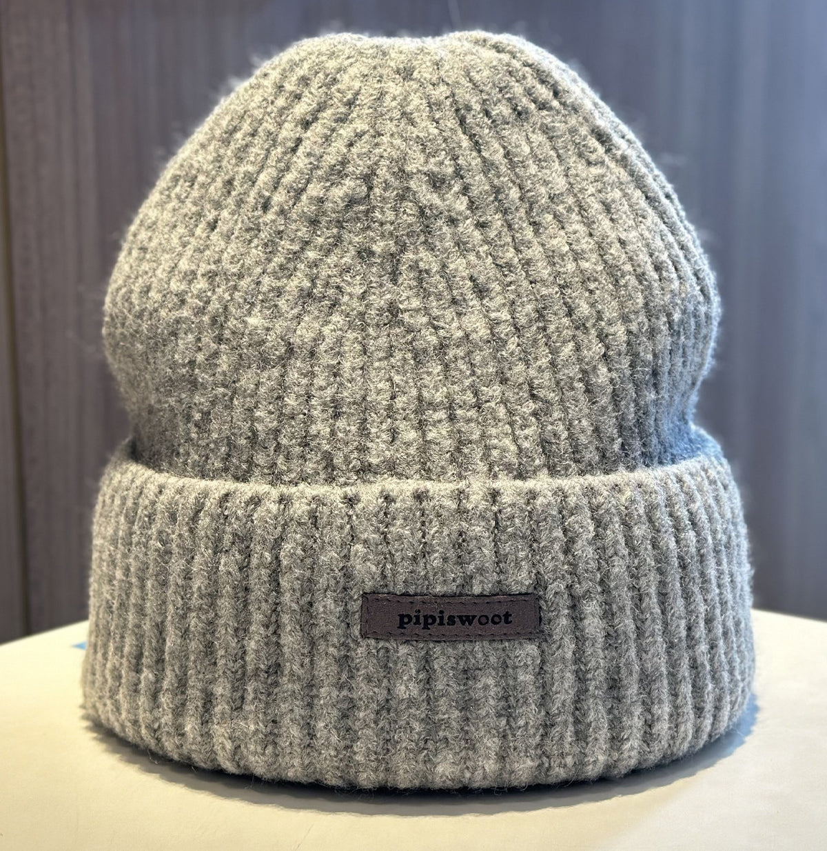 Heather gray ribbed knit beanie hat with cuff brim and pipiswoot logo patch