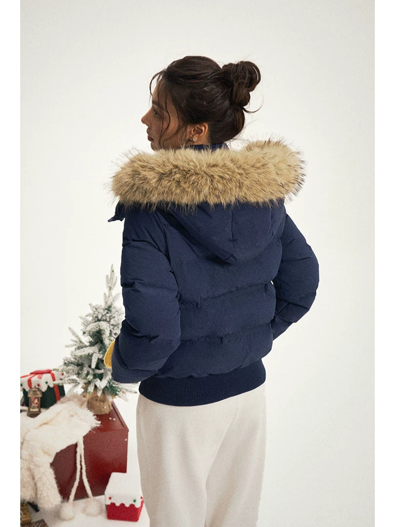 Women's navy puffer jacket with fur-trimmed hood, back view with quilted panels