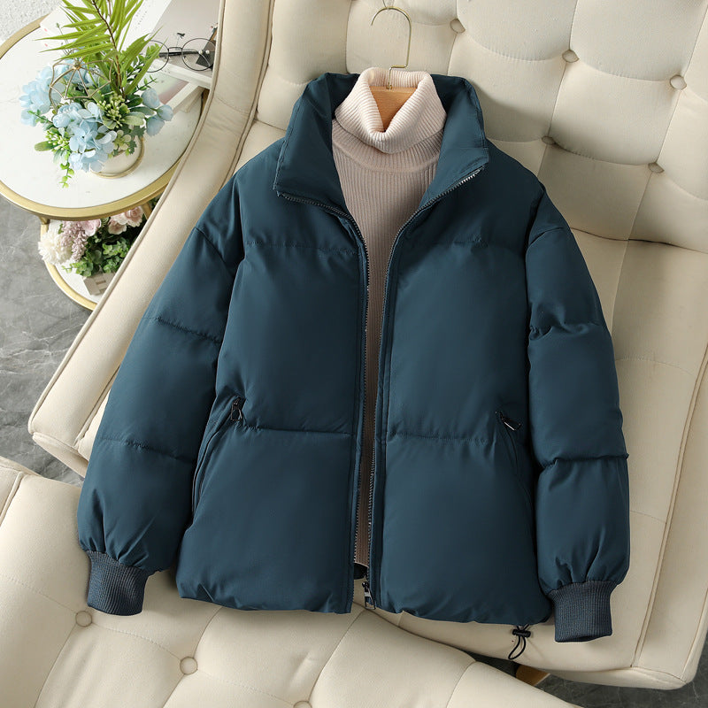 Short dark blue puffer jacket with full zip, stand collar, and ribbed cuffs