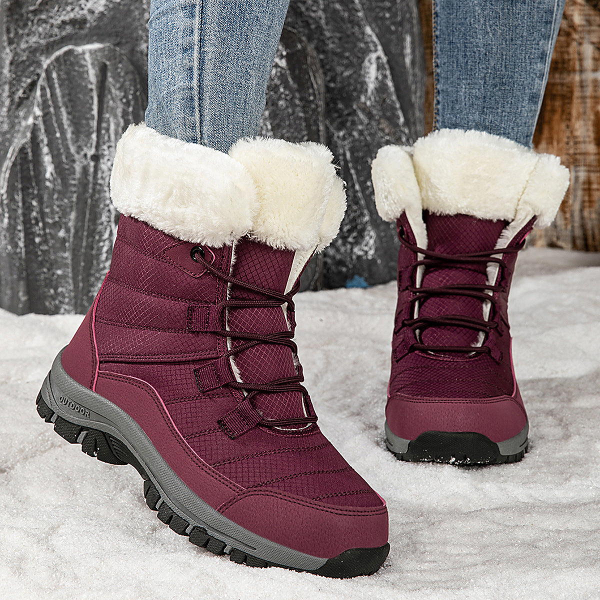Women’s dark red mid-top winter snow boots with faux fur cuffs, lace-up and tread sole