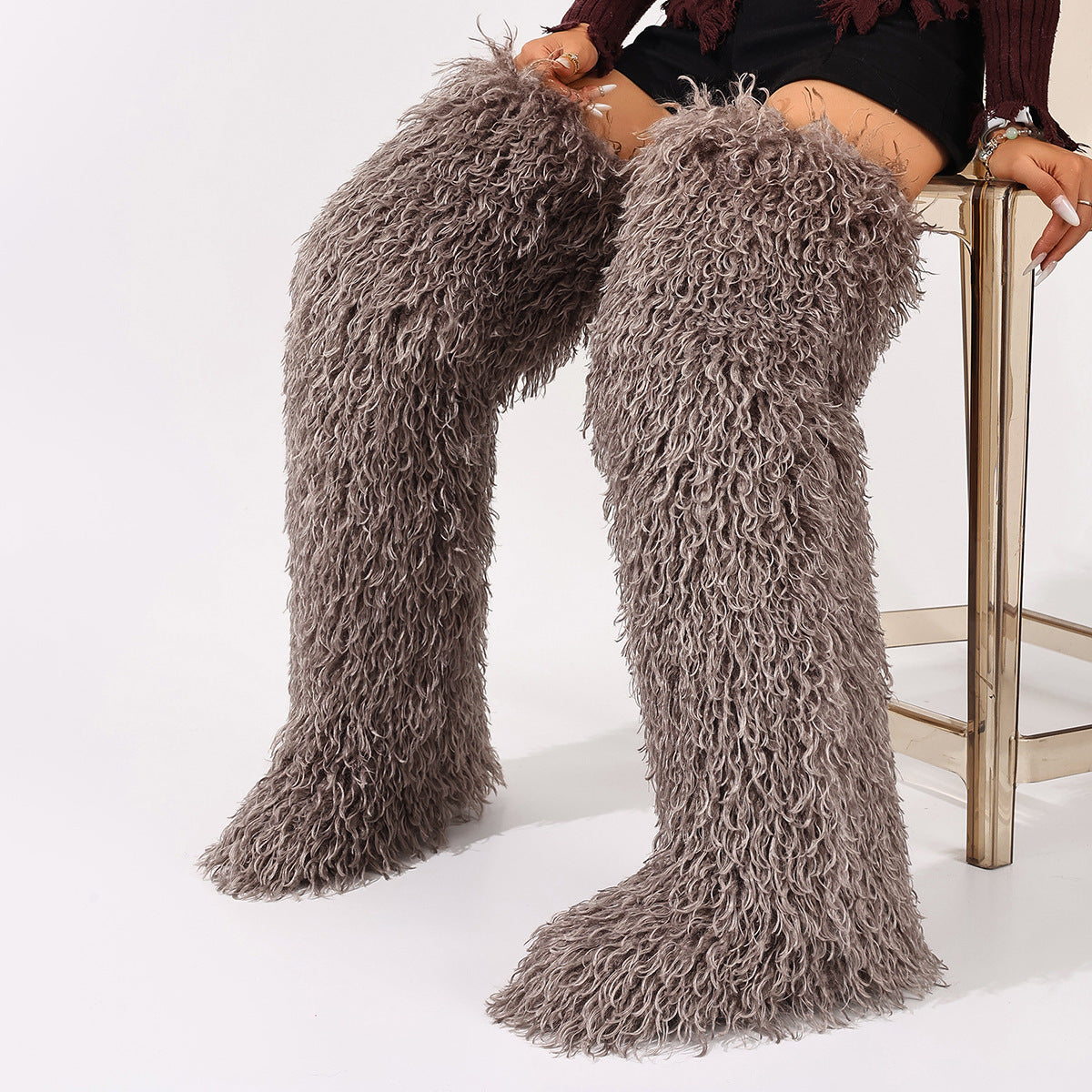 Dark gray faux fur thigh-high boots with curly pile