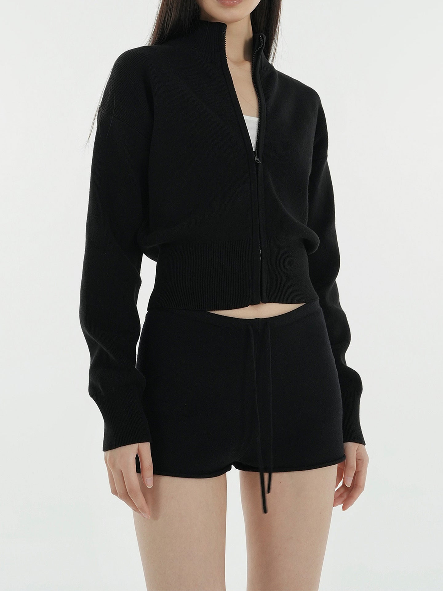 Black zip-up cropped mock neck knit cardigan with ribbed hem and drawcord