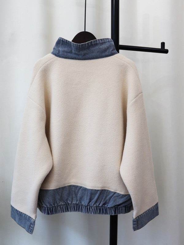 Beige back of zip-front knitted cardigan with blue denim trim and ribbed hem