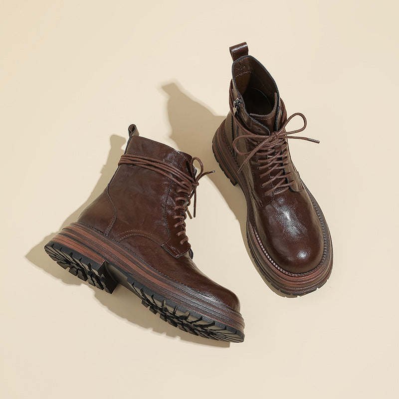 Brown lace-up ankle combat boots pair, stitched upper and treaded soles