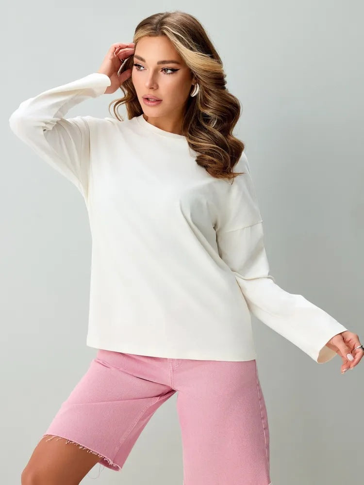 White round-neck top with long sleeves and a relaxed fit