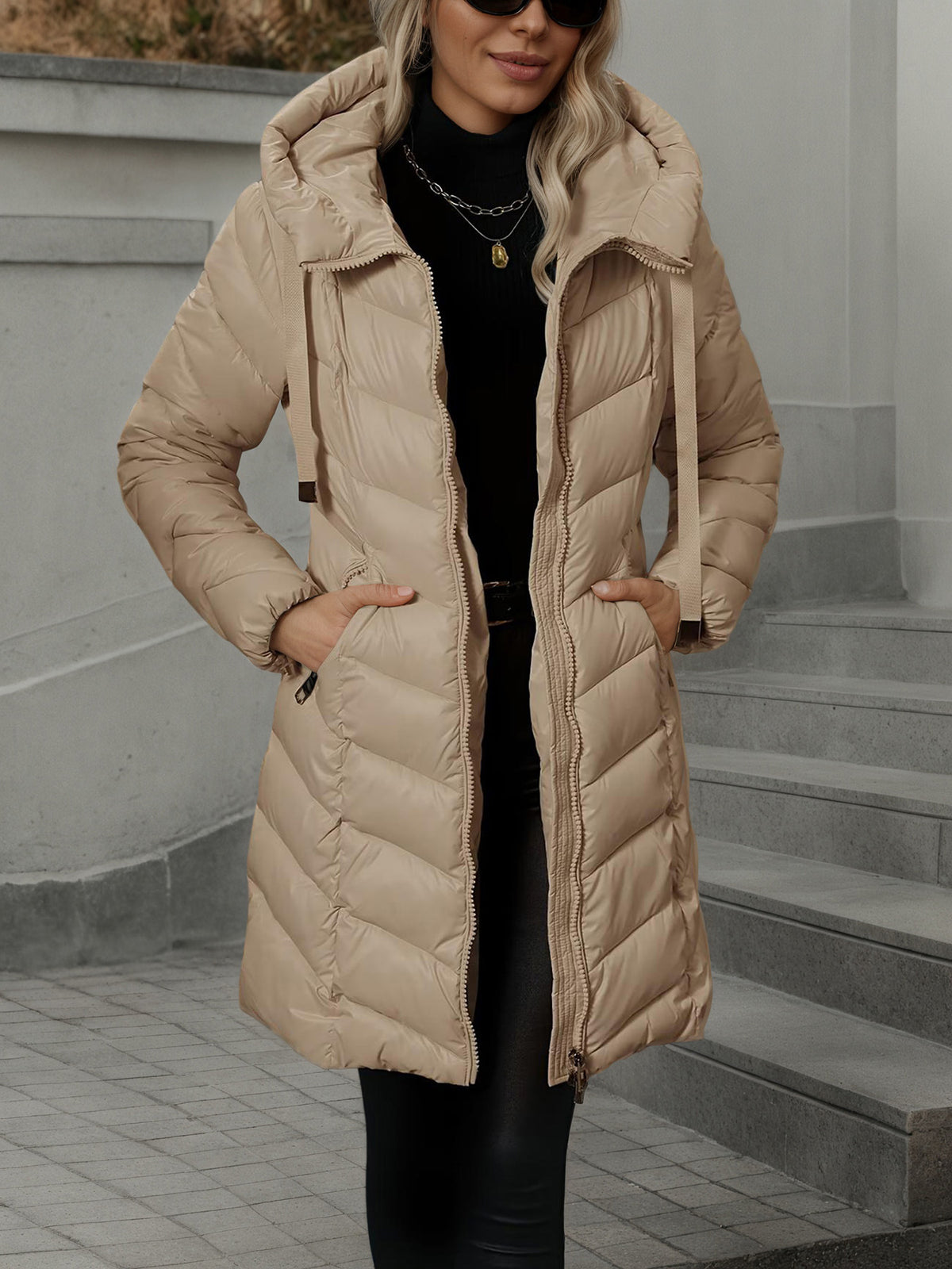 Women's long beige quilted puffer coat with hood and zip-front closure