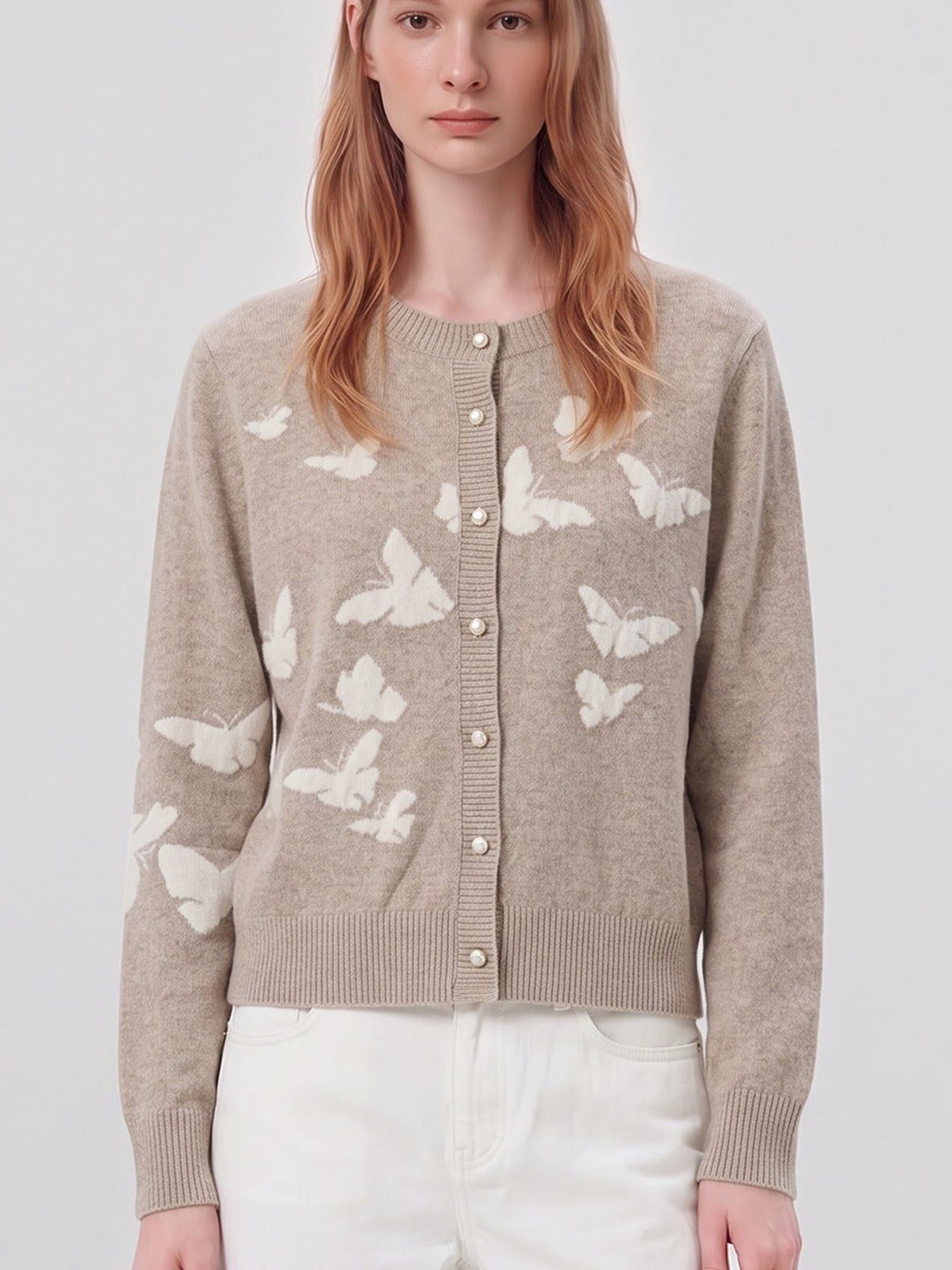 Close-up of women’s sand butterfly knit cardigan with button placket and ribbed hem