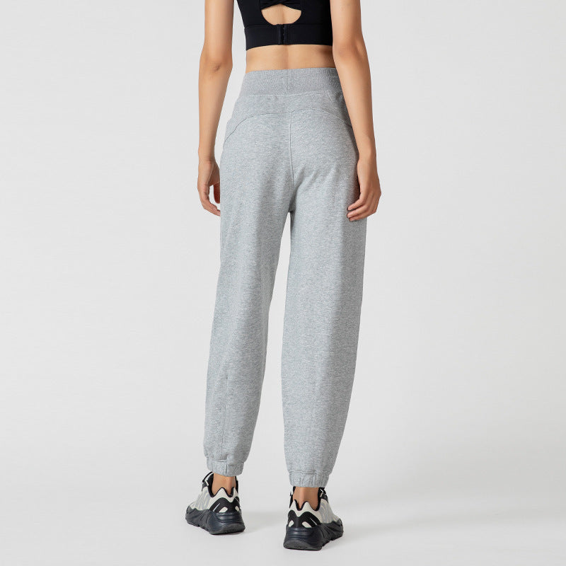 Gray jogger pants shown from the back, with a wide waistband and cuffed ankles