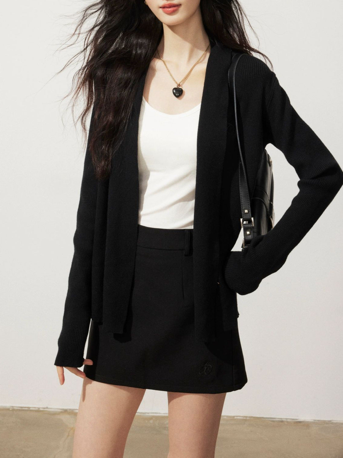 Black knitted cardigan sweater jacket, open front, long sleeves, side pockets