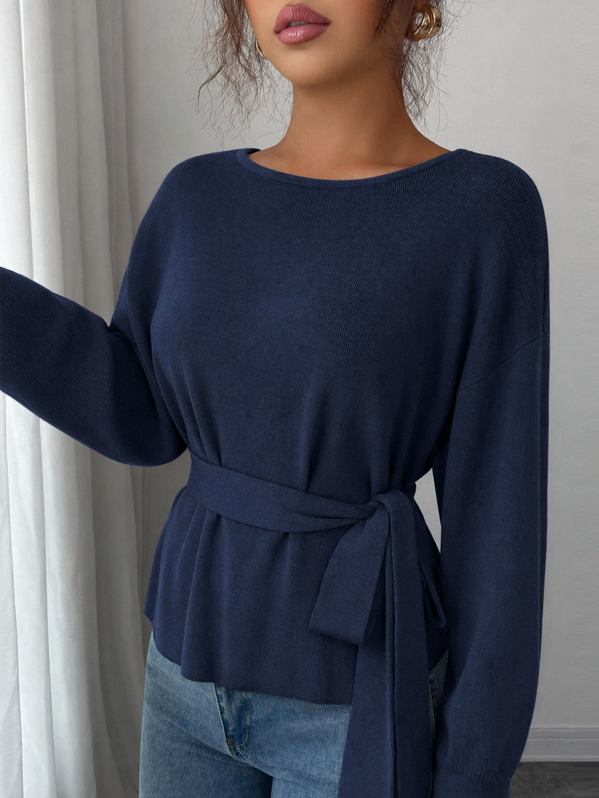 Women's dark blue long-sleeve knit sweater with a round neck and waist tie