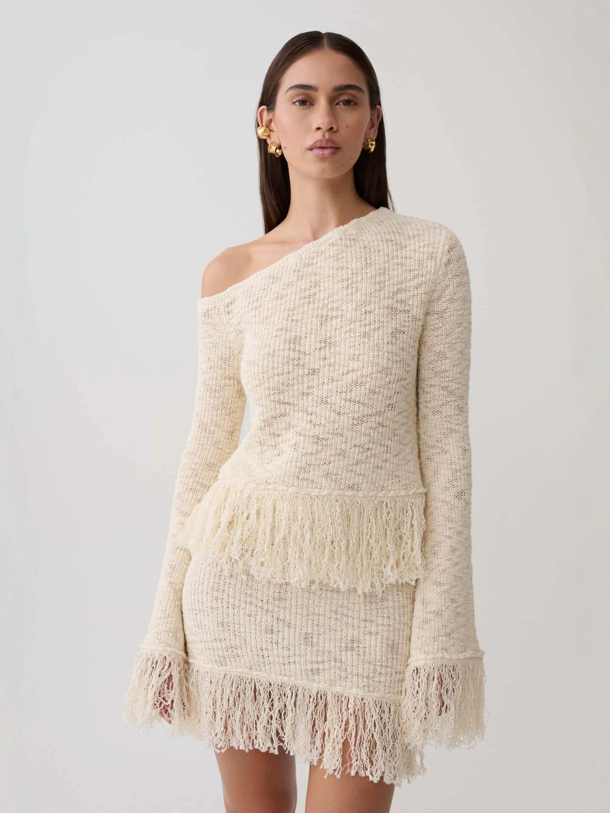 Apricot knitted off-shoulder long-sleeve top with layered fringe hem and hollow knit texture