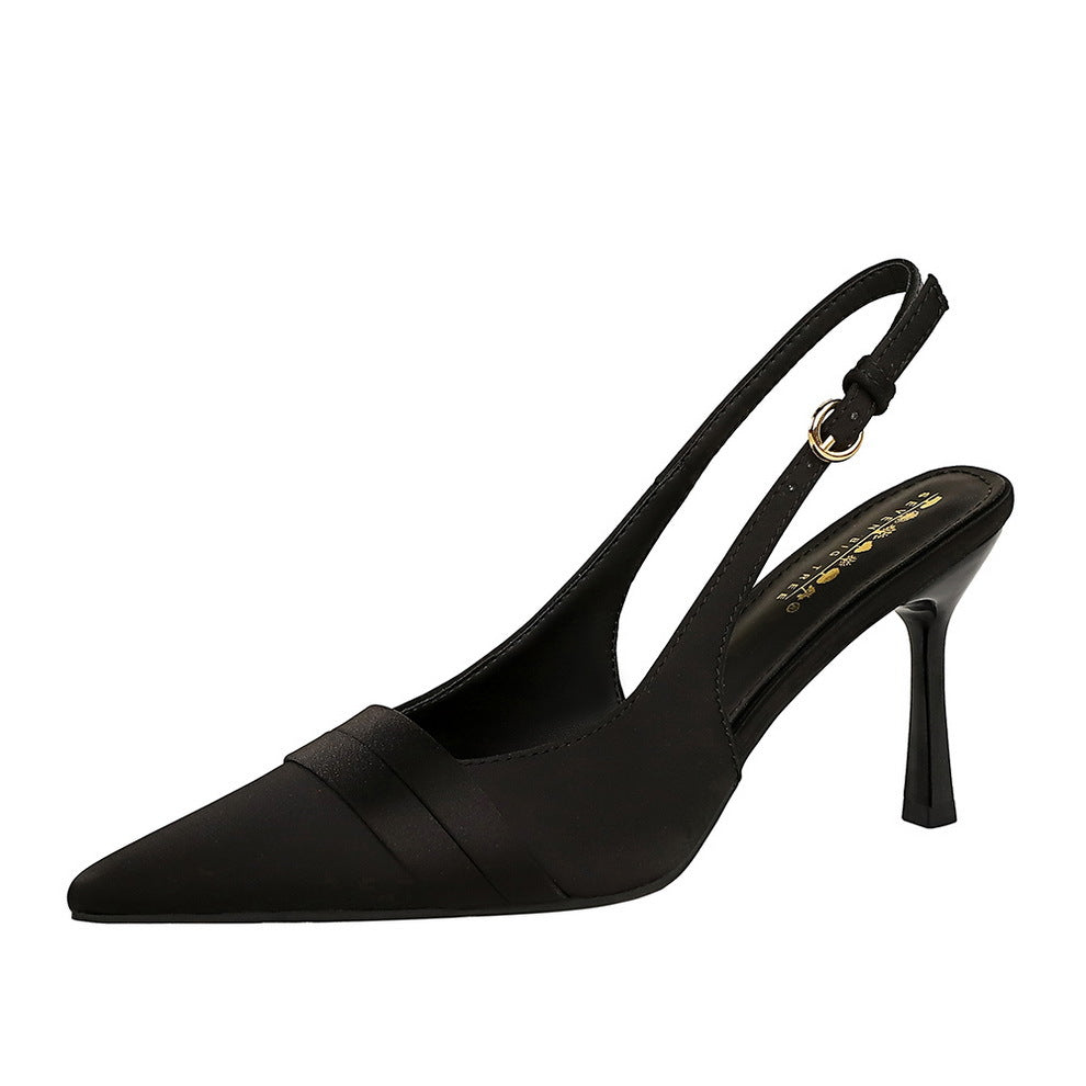 Black satin pointed-toe slingback high heels with cut-out back strap and stiletto