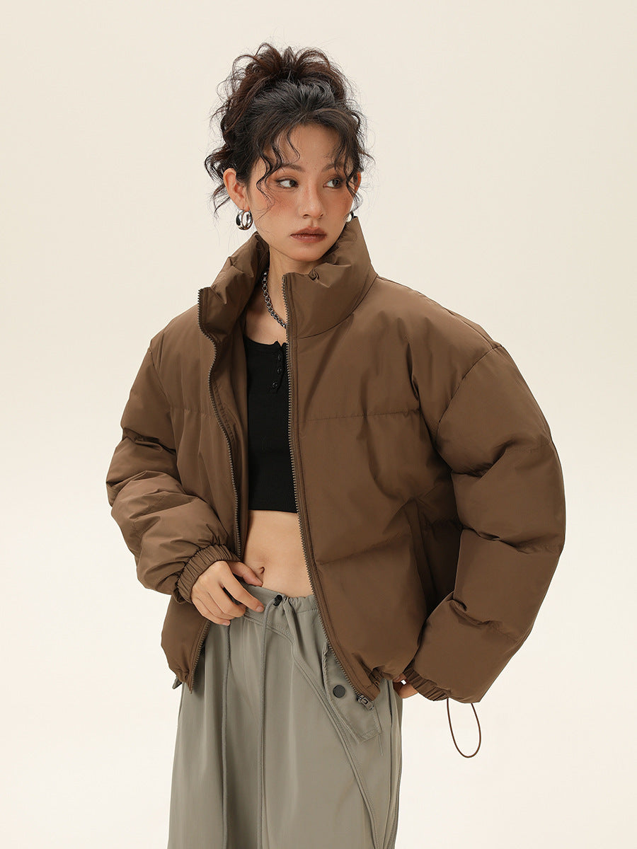 Women’s khaki cotton-padded jacket with stand collar and full-length zipper.