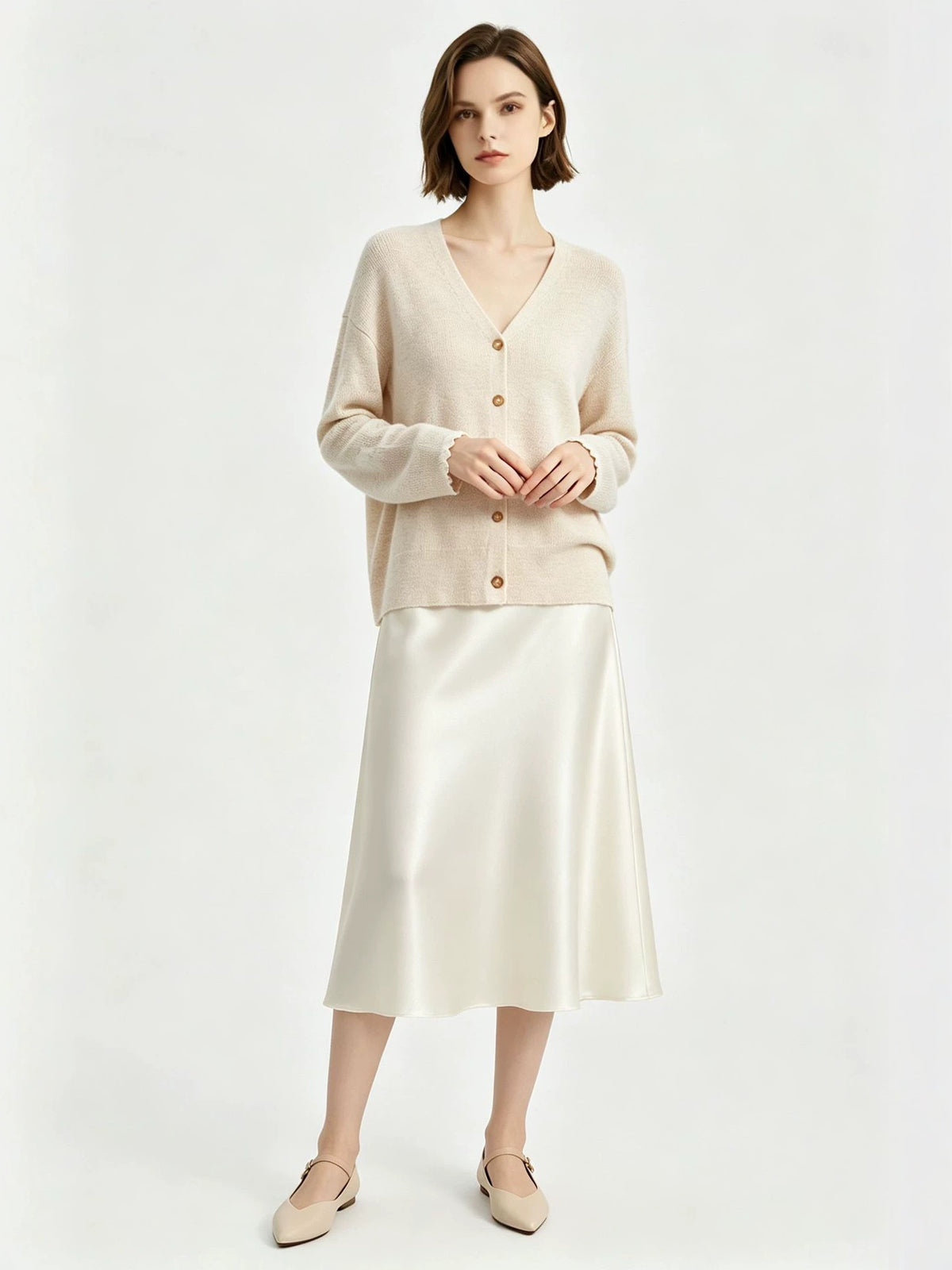 Women’s light beige V-neck lambswool cardigan sweater, button front, long sleeves.
