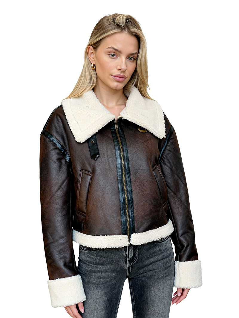 Women's brown leather jacket with cream sherpa collar, zip front, and cream waist band