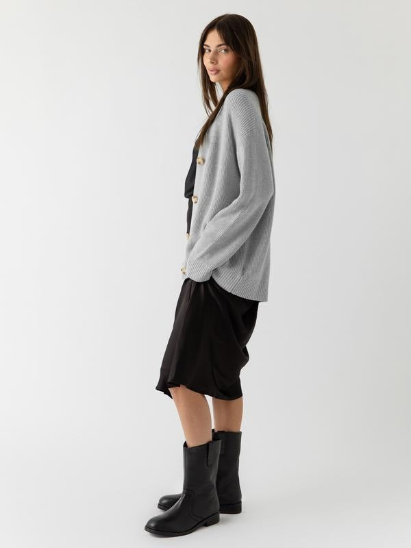 Light gray button-front cardigan shown from the side, with a relaxed fit