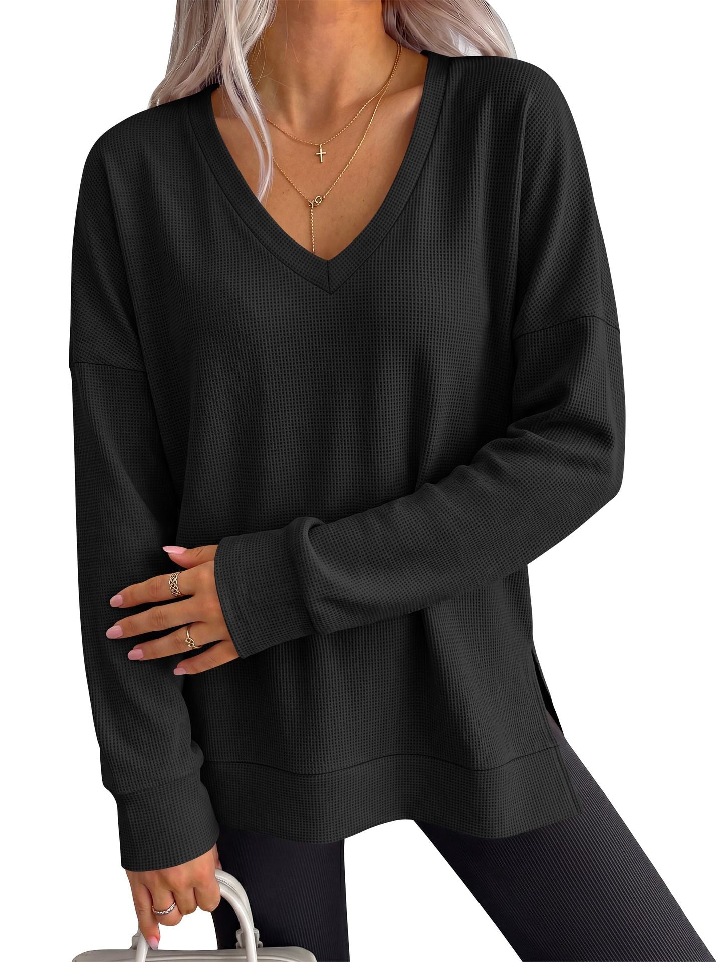 Women’s black V-neck long-sleeve waffle knit loose T-shirt top, relaxed drape.