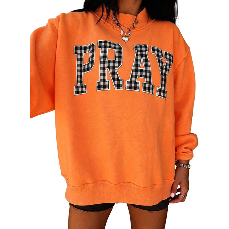 Women's orange raglan sweatshirt with 'PRAY' polka-dot letter graphic