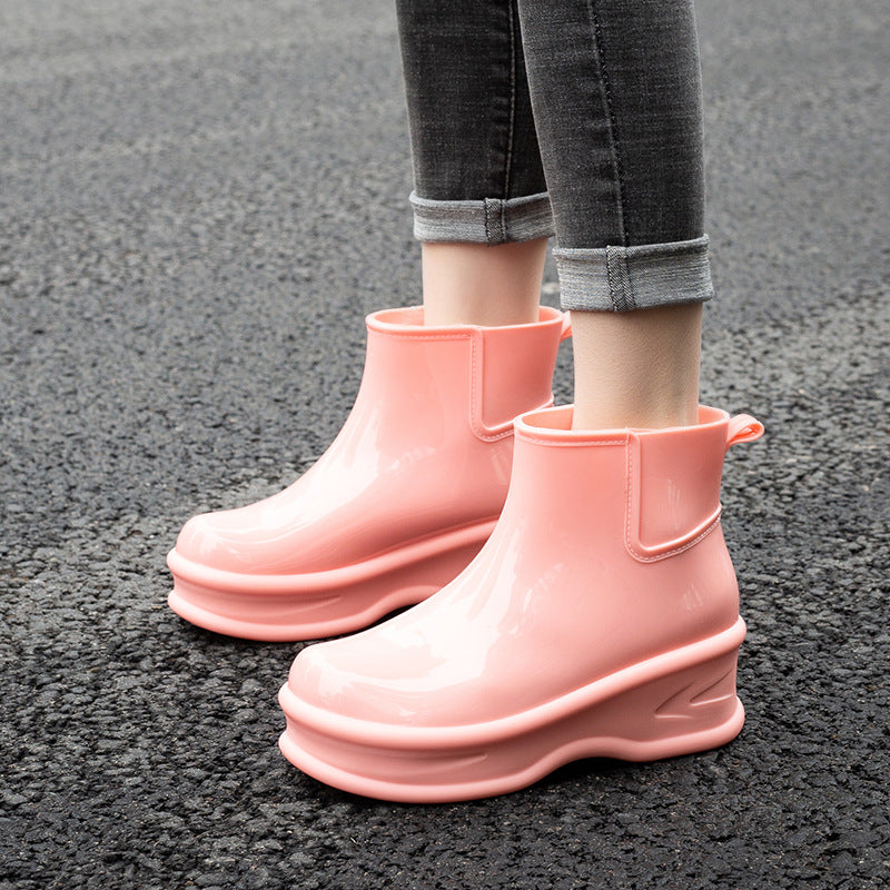 Light pink glossy mid-calf rain boots with side pull-tab and thick platform sole