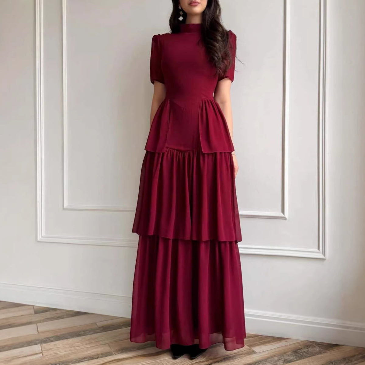 Burgundy chiffon tiered maxi dress with short puff sleeves and ruffle bodice.