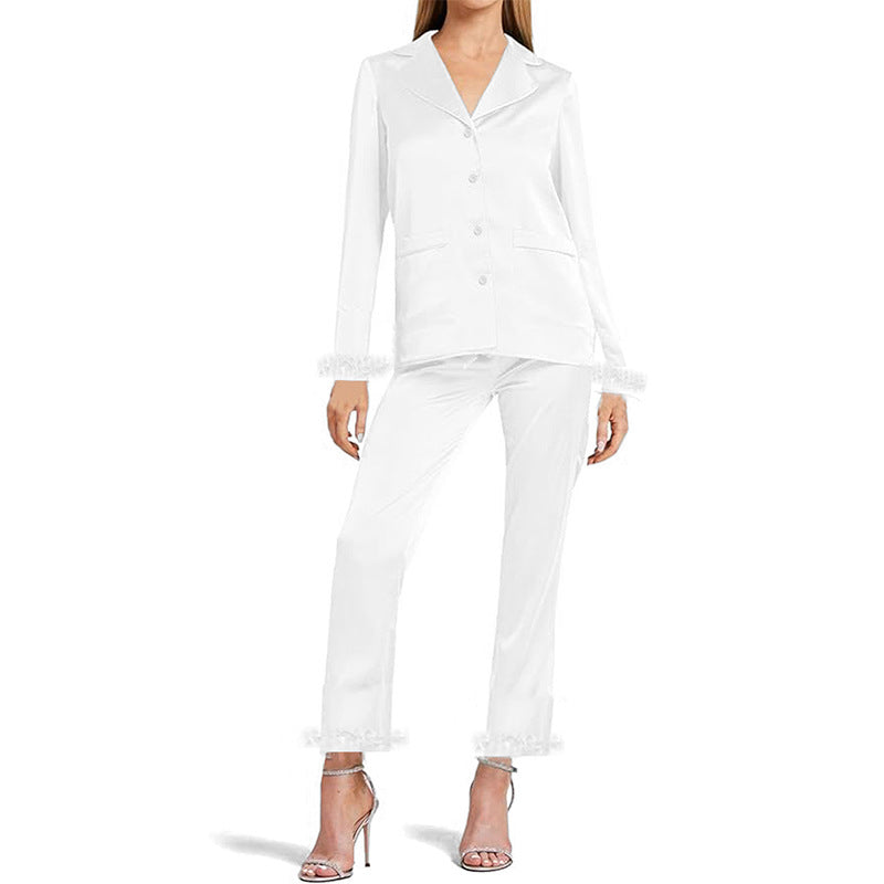 White long-sleeve pajama set with chest pocket and feather-trim cuffs, full front