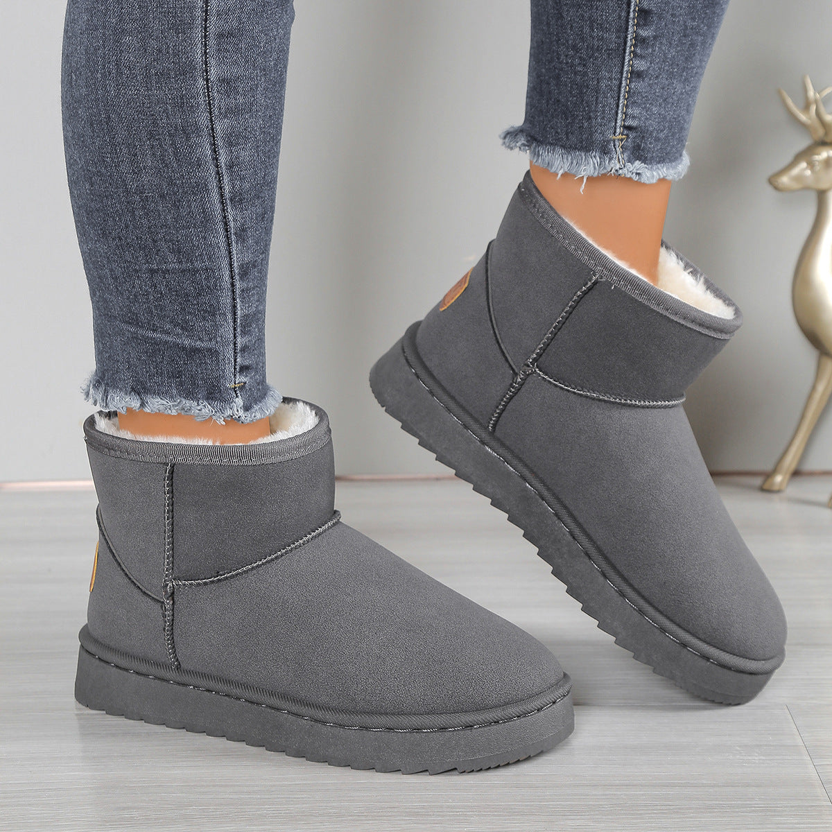 Fleece-lined snow boots in dark gray suede with white lining and molded traction sole