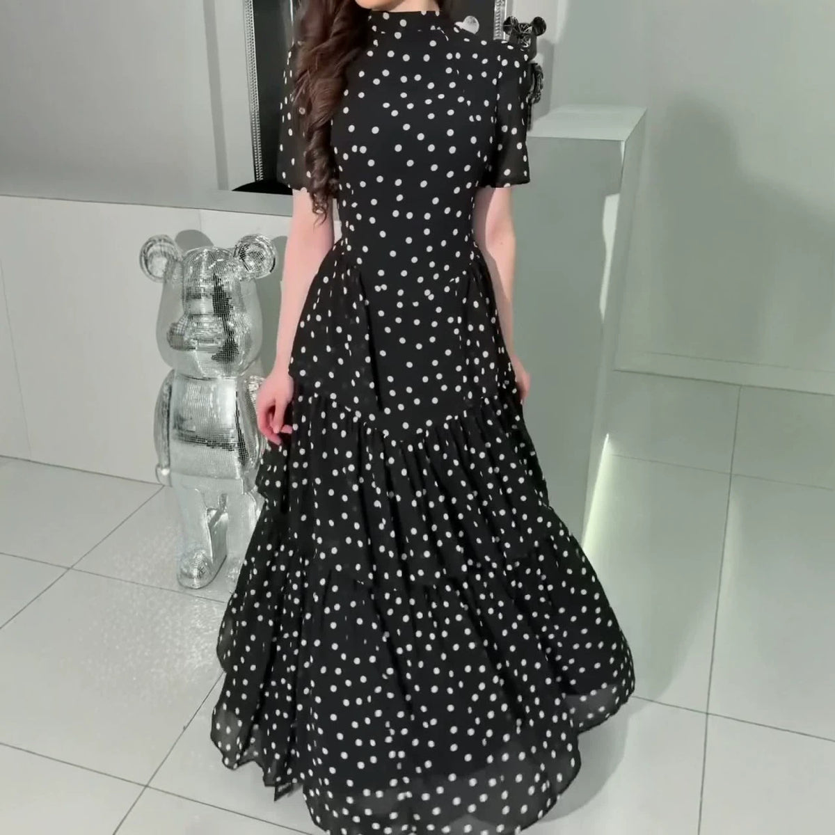 Black polka dot maxi dress with high neck, puff sleeves, tiered ruffle skirt