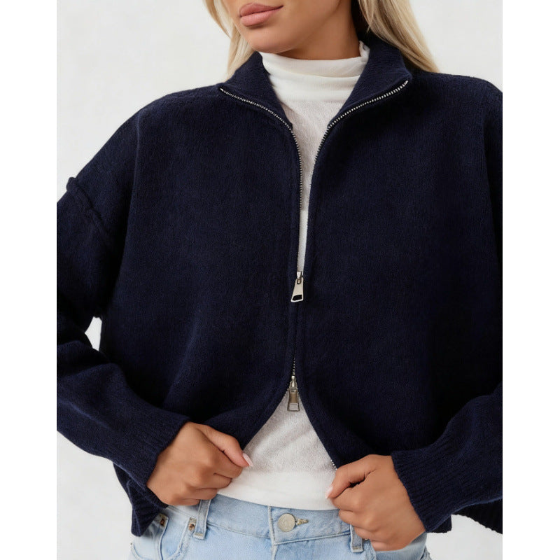 Women’s oversized zip-up cardigan sweater, navy blue funnel neck, zipped front.