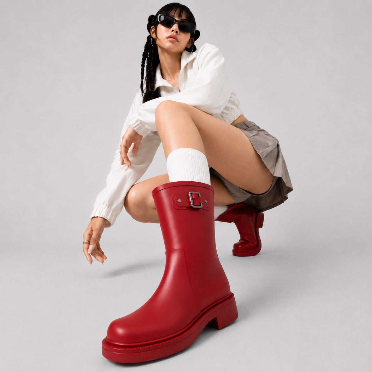 Women's red mid-calf rain boots with buckle detail and thick lug sole