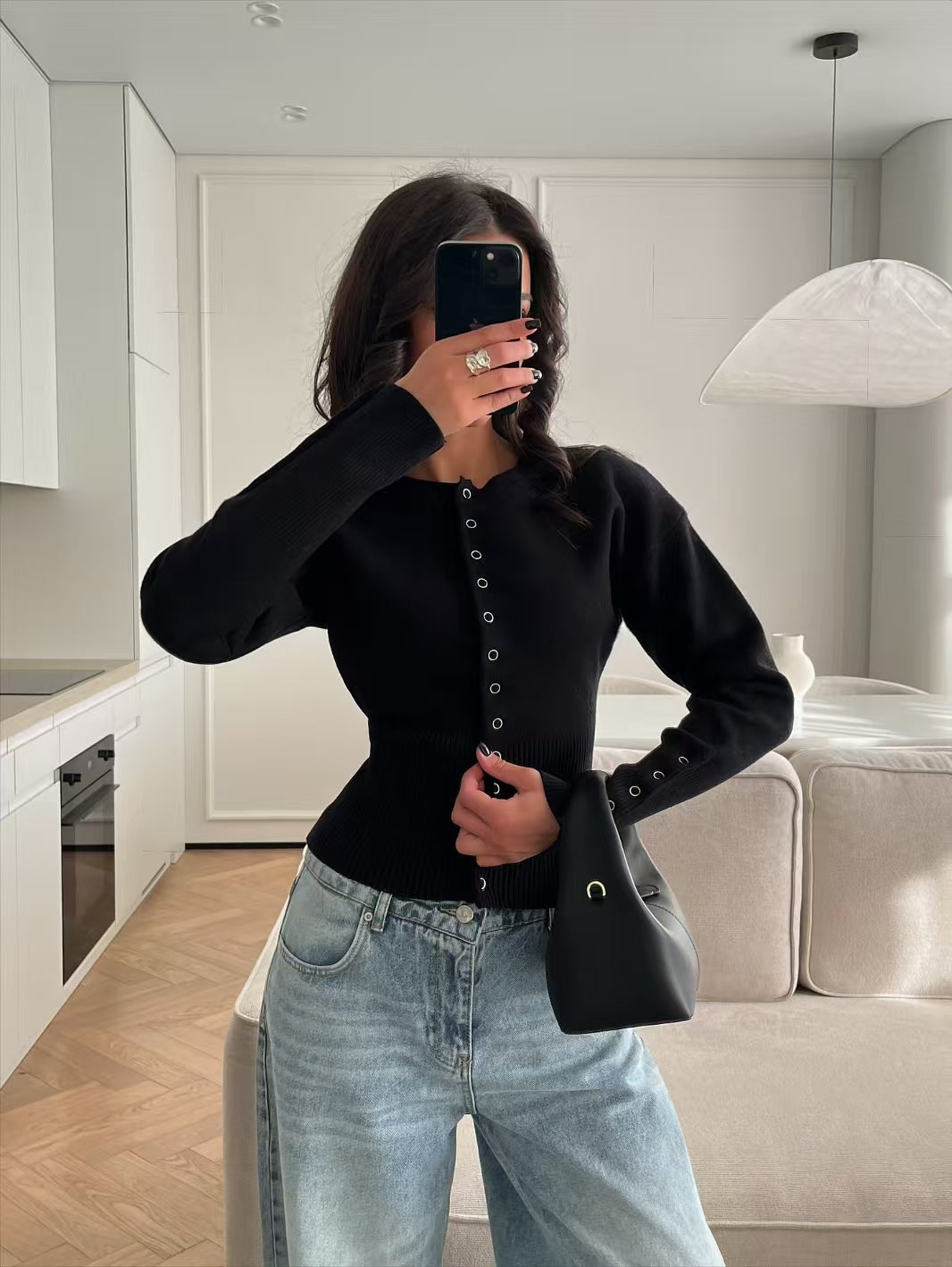 Women’s black knitted cardigan sweater with button-front placket and long sleeves