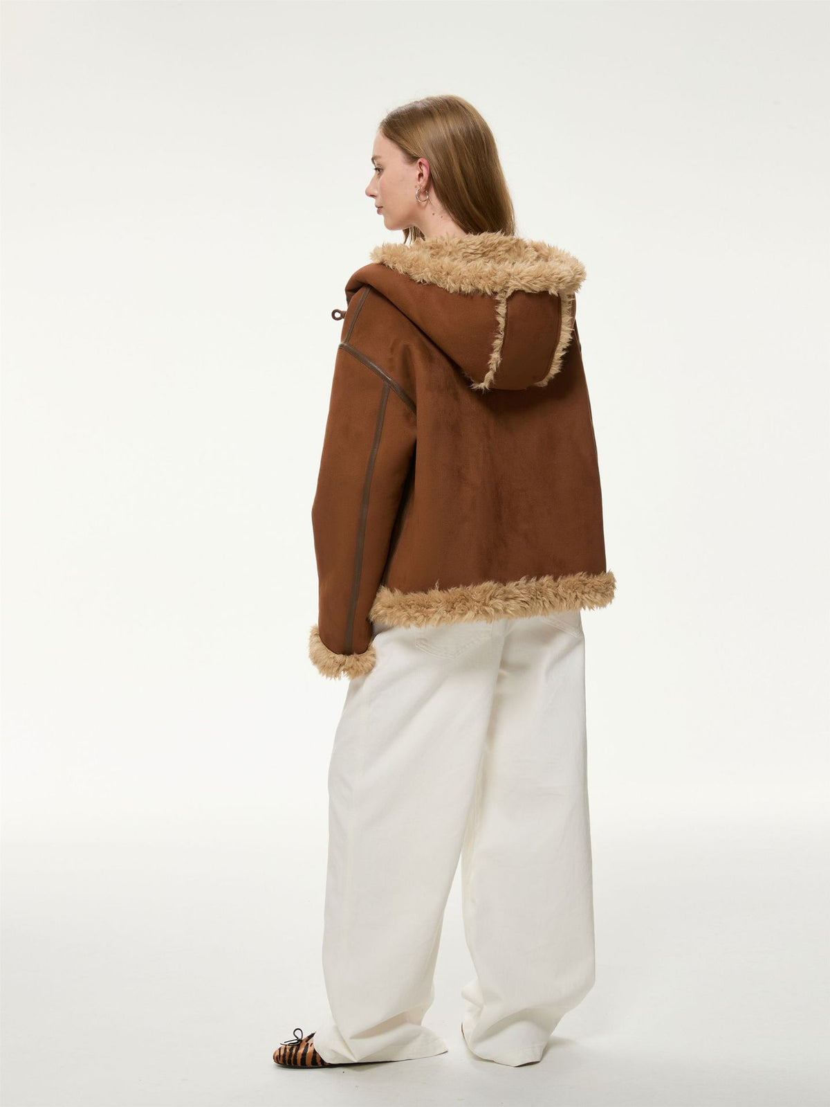 Women’s brown hooded suede shearling jacket, rear view with hood and shearling hem