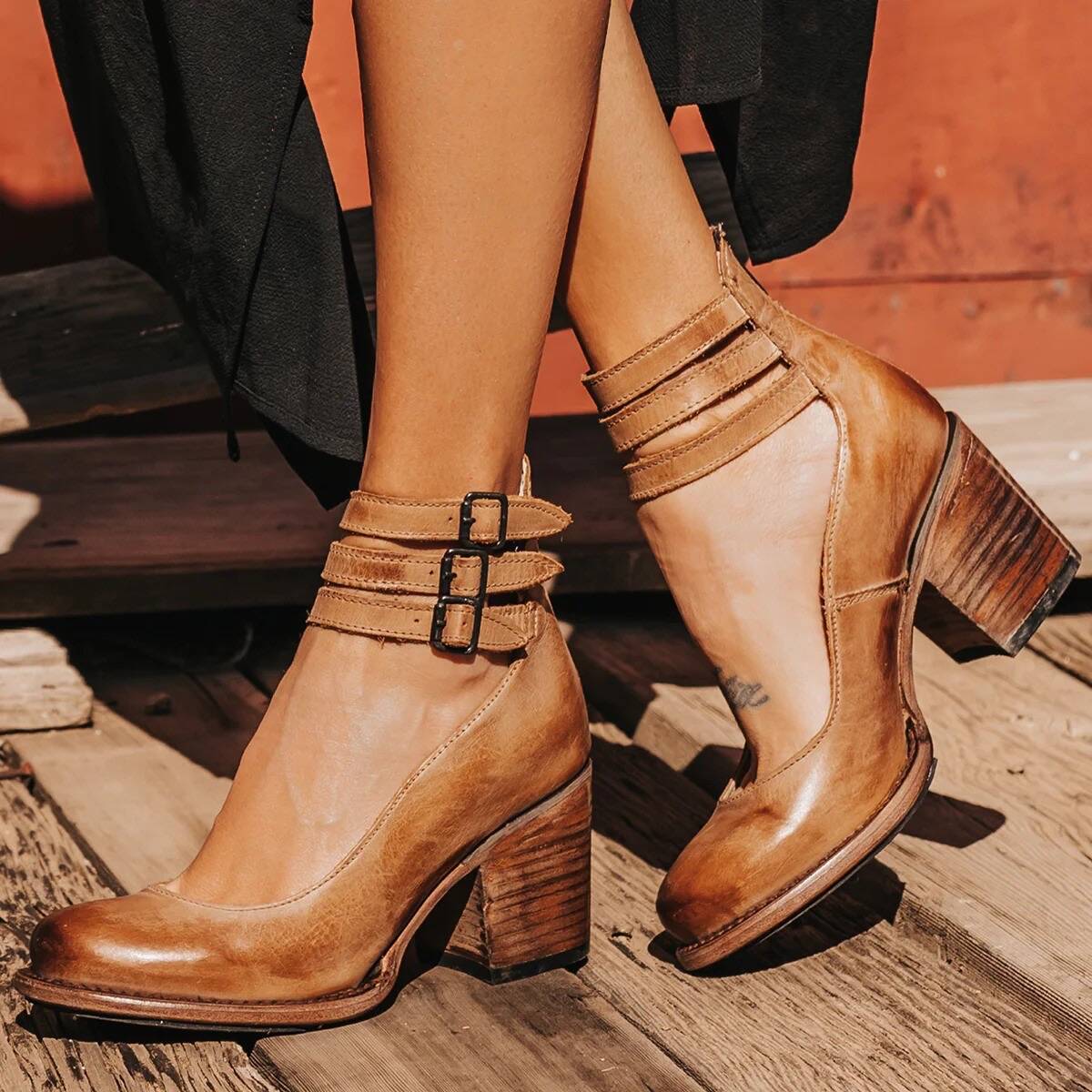 Tan ankle boots with stacked heel, ankle strap, and buckle closure