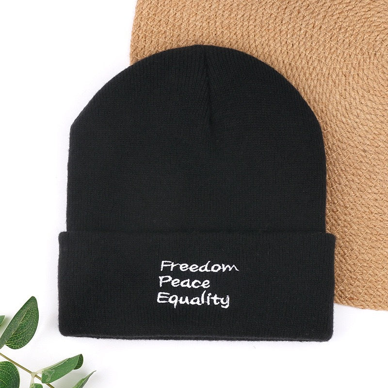 Black knit beanie with “Freedom Peace Equality” text embroidery on cuff