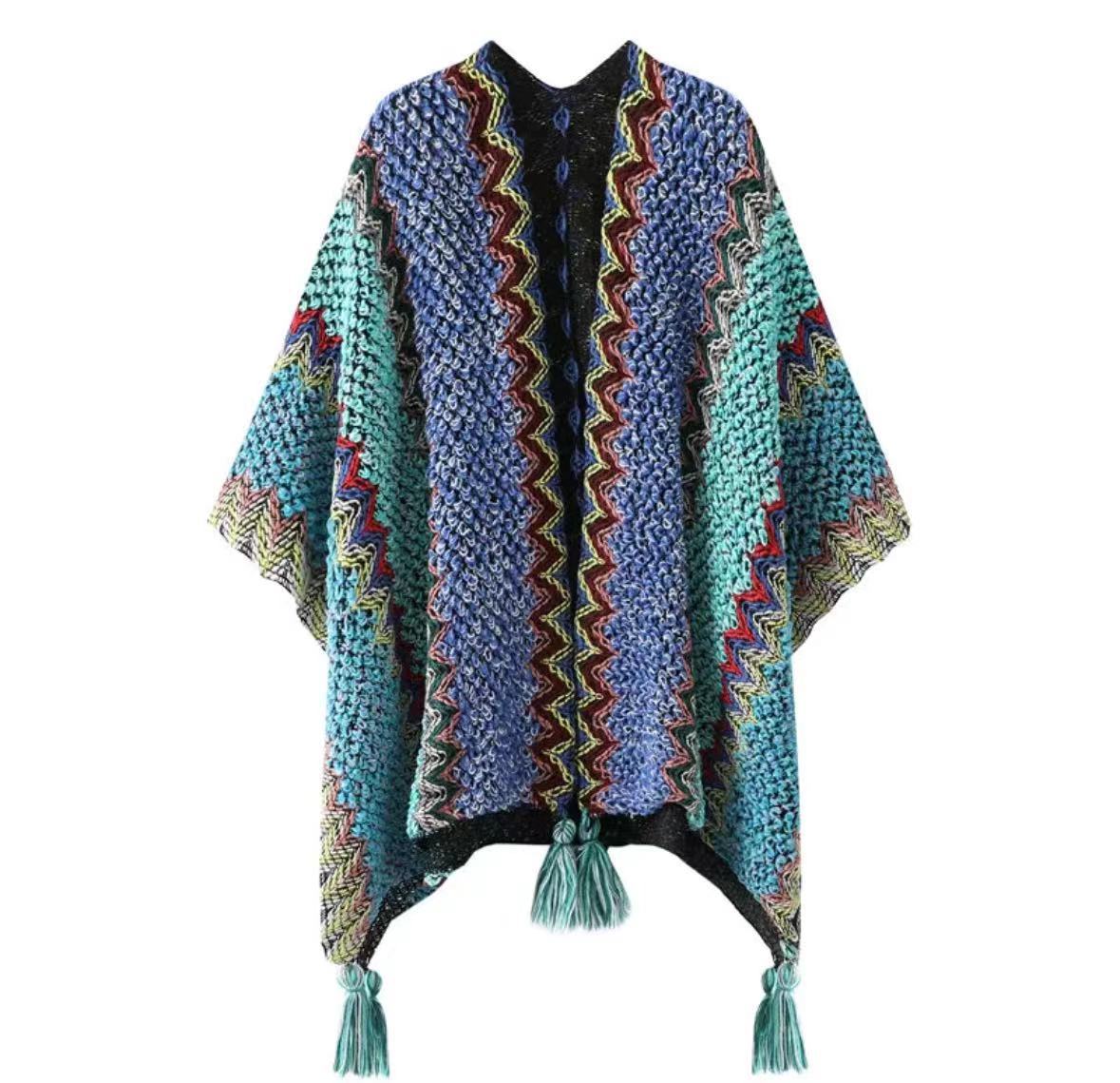 Blue and teal knitted poncho shawl with multicolor zigzag stripes and tassels