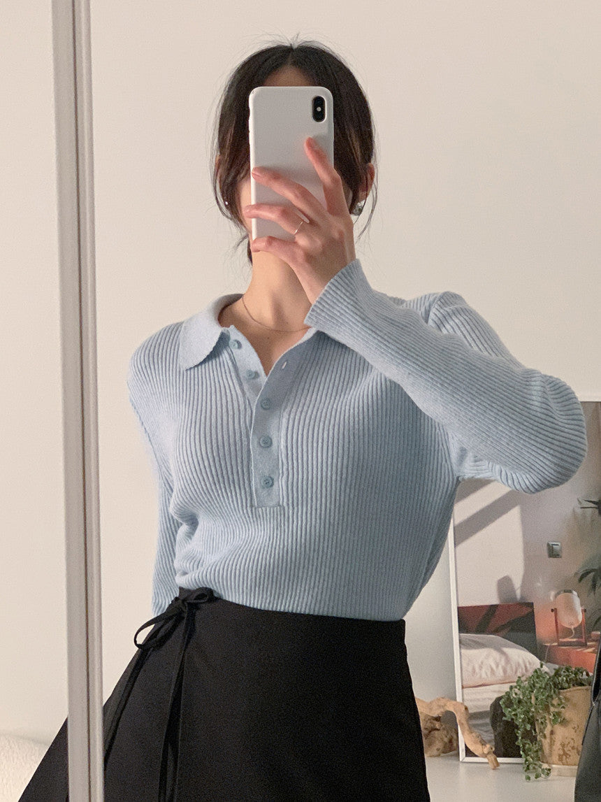 Light blue knit polo collar long-sleeve top with button placket and vertical ribbing.