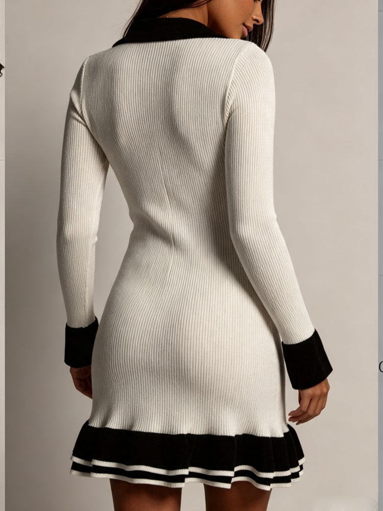 White knit mini dress back view with long sleeves, black cuffs, ruffle hem