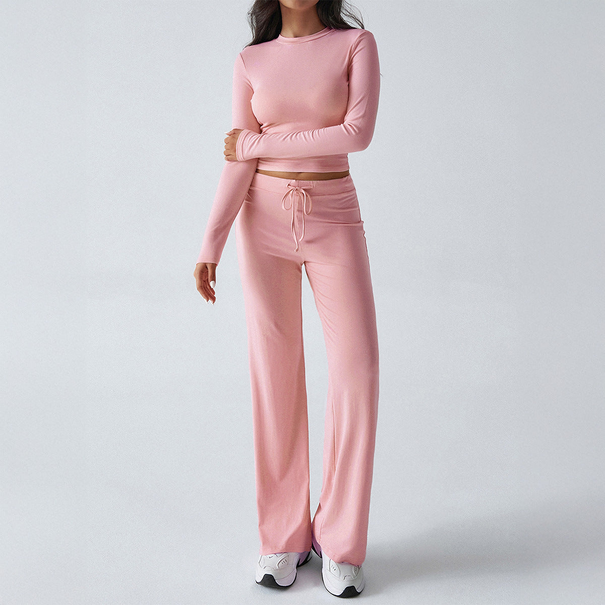 Pink two-piece sweatsuit set: cropped long-sleeve top and wide-leg sweatpants with tie waist
