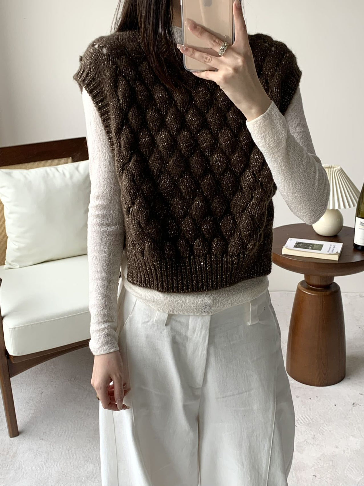 Brown chunky cable-knit sweater vest with sleeveless crew neck and ribbed hem