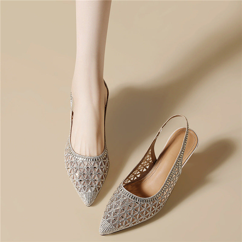 Silver pointed-toe slingback heels with geometric cutout pattern and low heel.