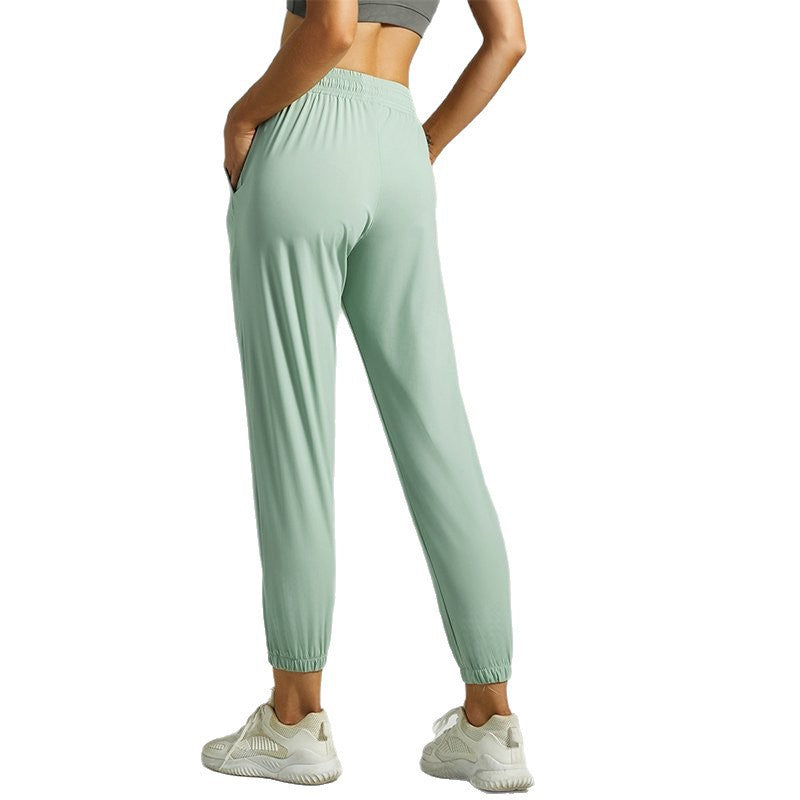 Women's light green jogger pants with drawstring waist and tapered cuffed hems