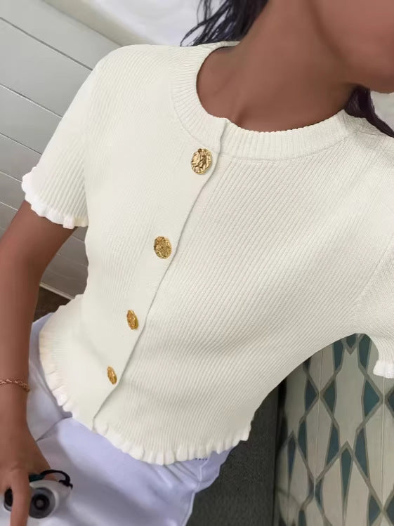 White short-sleeve knit cardigan with gold button front and ruffled sleeve cuffs
