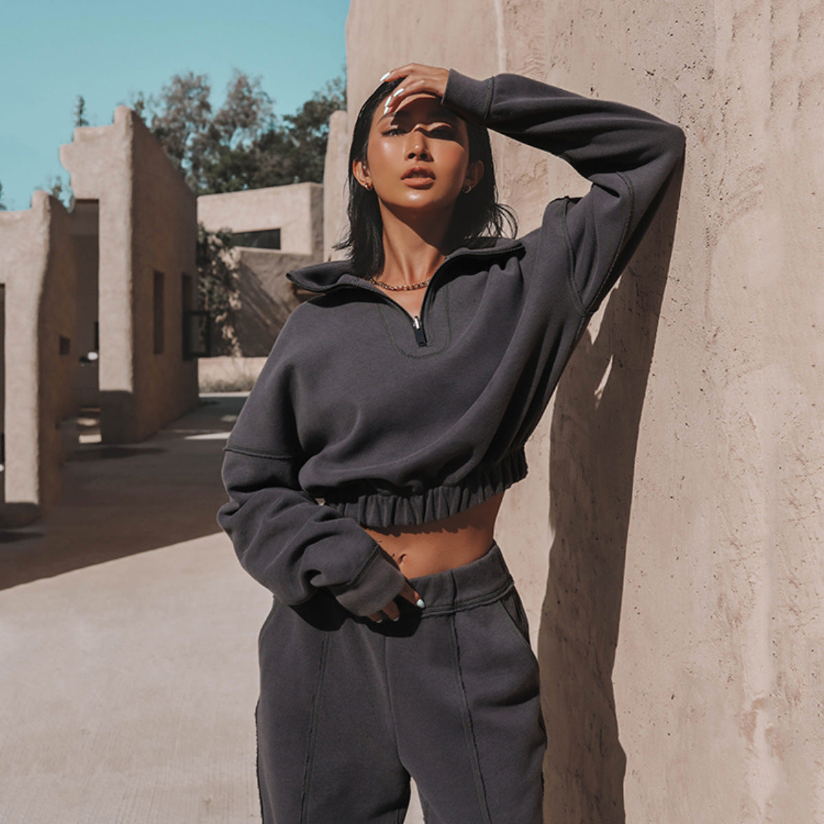 Women's charcoal quarter-zip cropped sweatshirt with elastic hem and matching joggers