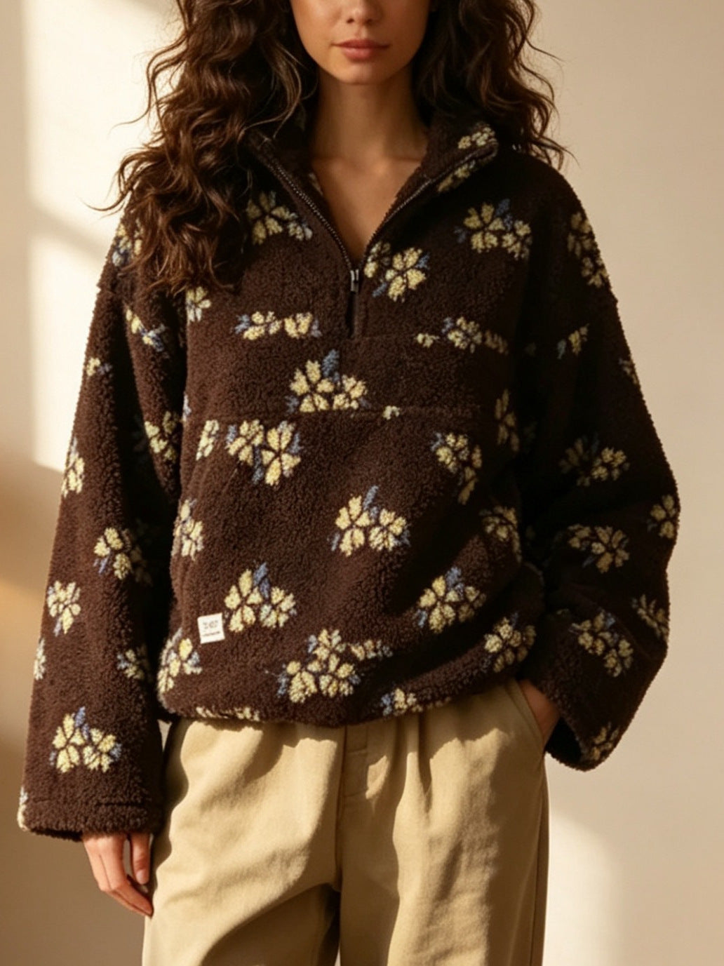 Dark brown fleece half-zip hoodie with light flower pattern and long sleeves