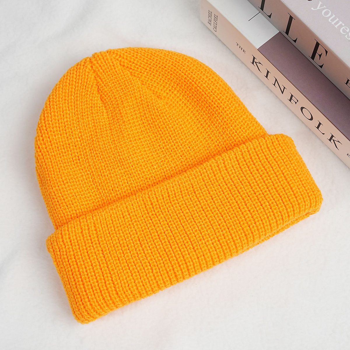 Thick knitted beanie hat in bright orange with ribbed cuff and folded brim