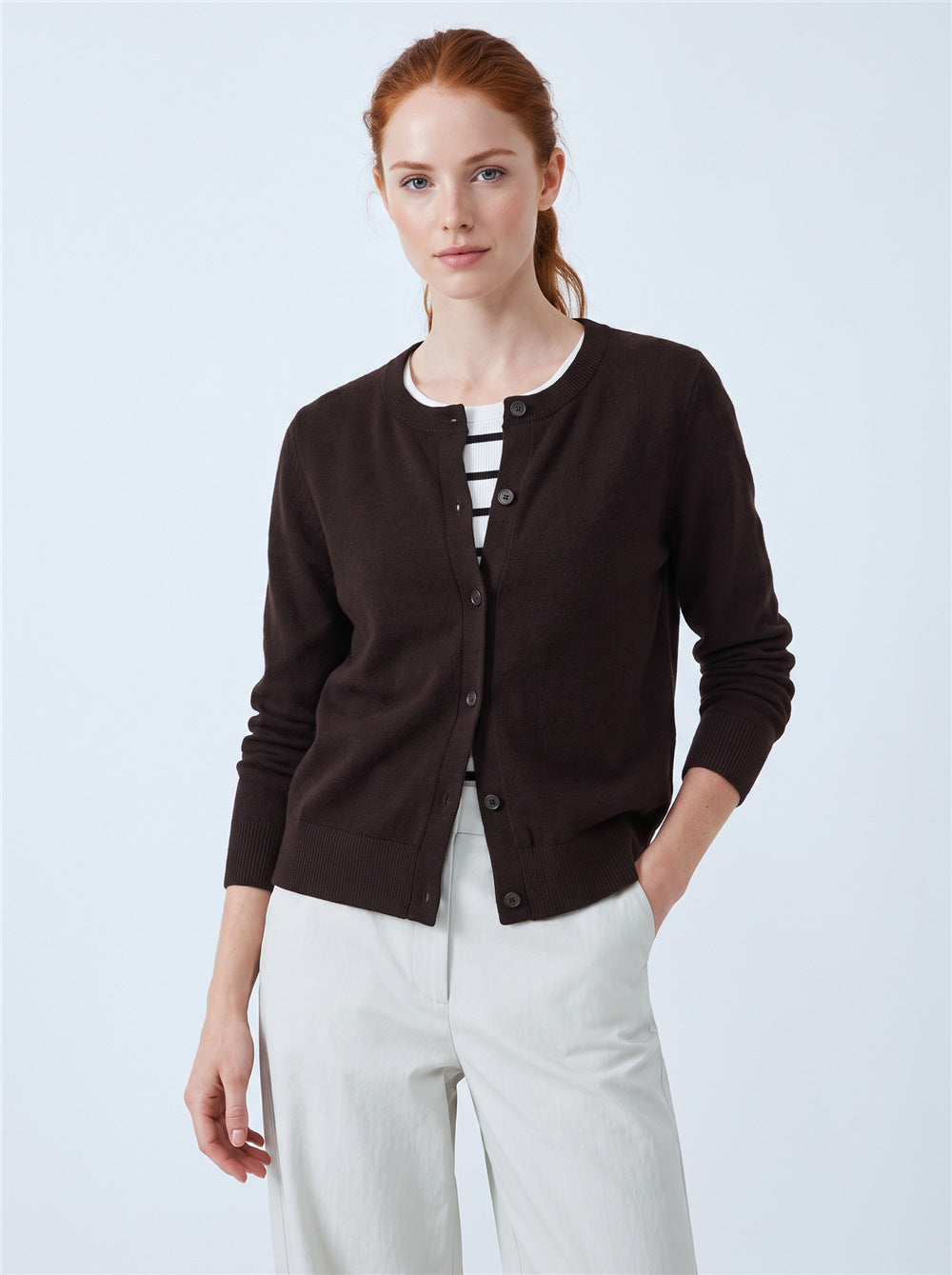 Women’s dark brown button-front cardigan sweater with faux striped tee underlayer