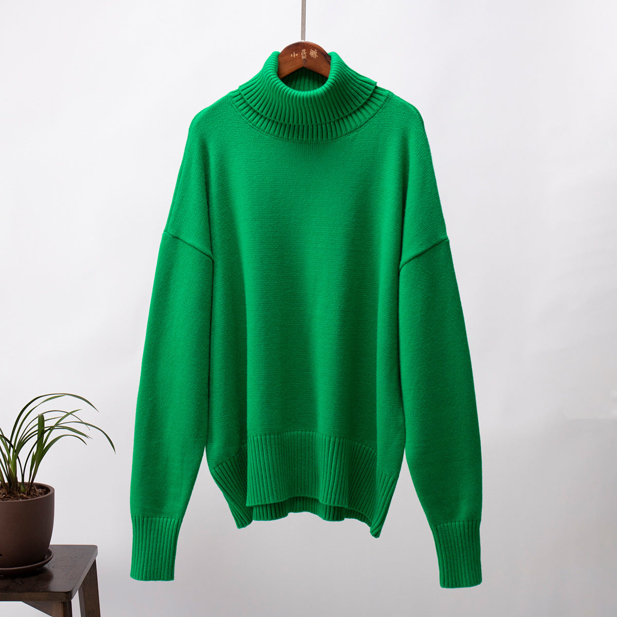 Green knit turtleneck pullover sweater with loose fit, ribbed hem and cuffs